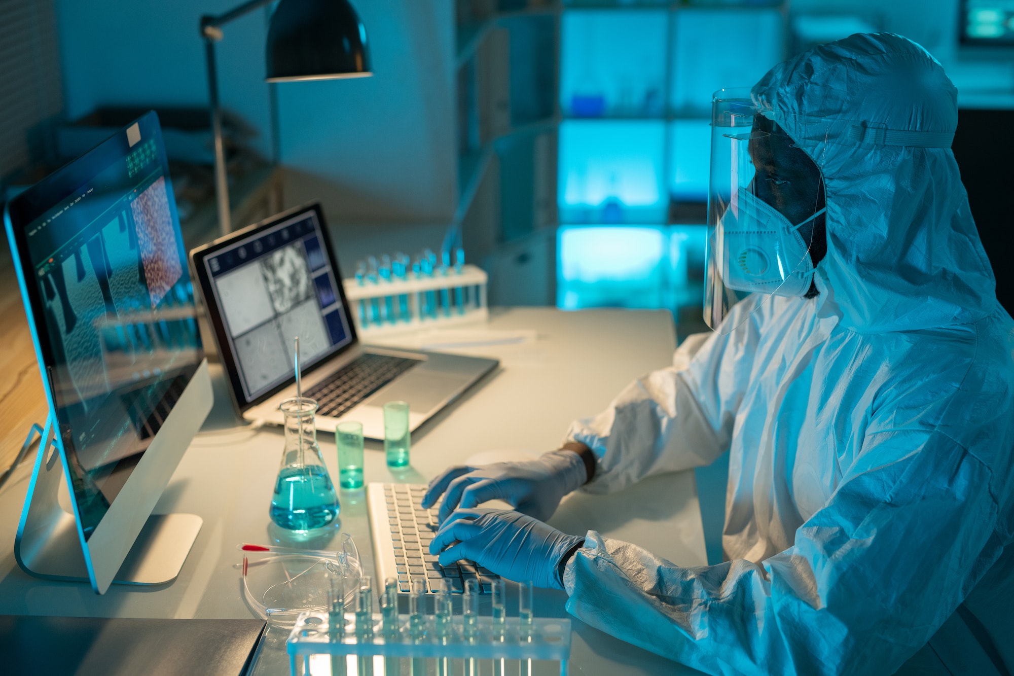 African American male scientist analyzing results of scientific experiment